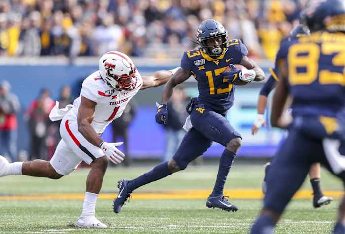 West Virginia Mountaineers wide receiver Sam James (13) runs after a catch against Texas Tech Red Raiders linebacker Jordyn Brooks (1) during the first quarter at Mountaineer Field at Milan Puskar Stadium.